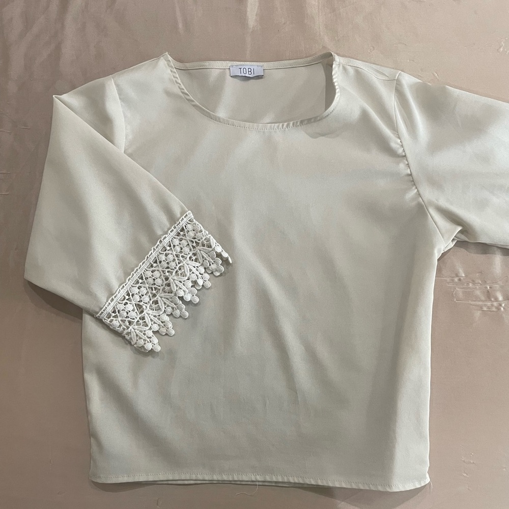 Tobi brand cream color blouse with lace sleeves